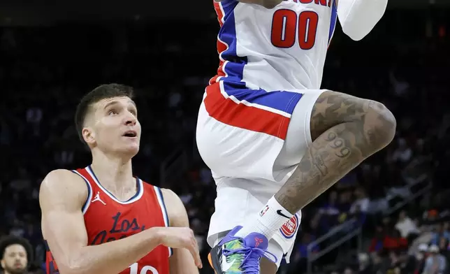 Detroit Pistons forward Ronald Holland II (00) goes to the basket past Los Angeles Clippers guard Bogdan Bogdanovic (10) during the first half of an NBA basketball game Monday, Feb. 24, 2025, in Detroit. (AP Photo/Duane Burleson)