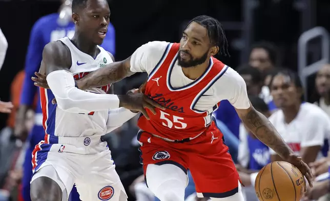 Los Angeles Clippers forward Derrick Jones Jr. (55) works the ball against Detroit Pistons guard Dennis Schroder, left, during the first half of an NBA basketball game Monday, Feb. 24, 2025, in Detroit. (AP Photo/Duane Burleson)