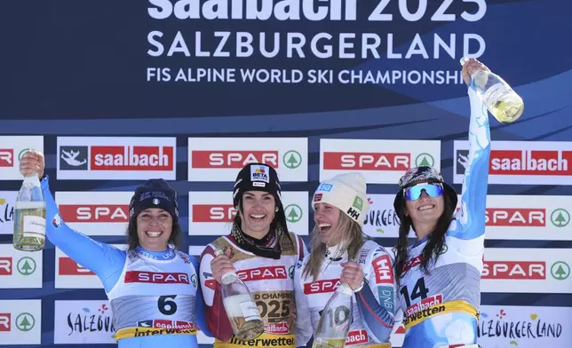 Austria's Stephanie Venier, second from left, winner of a women's Super-G, celebrates on the podium with second-placed Italy's Federica Brignone, left, and joint third-placed Norway's Kajsa Vickhoff Lie, second from right, and United States' Lauren Macuga, at the Alpine Ski World Championships, in Saalbach-Hinterglemm, Austria, Thursday, Feb. 6, 2025. (AP Photo/Giovanni Auletta)