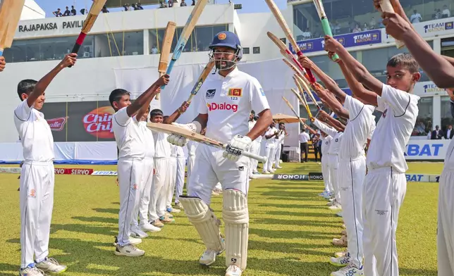 Sri Lanka's Dimuth Karunaratne who is playing his career last test match arrives to bat during the first day of the second test cricket match between Sri Lanka and Australia in Galle, Sri Lanka, Thursday, Feb. 6, 2025. (AP Photo/Lahiru Harshana)