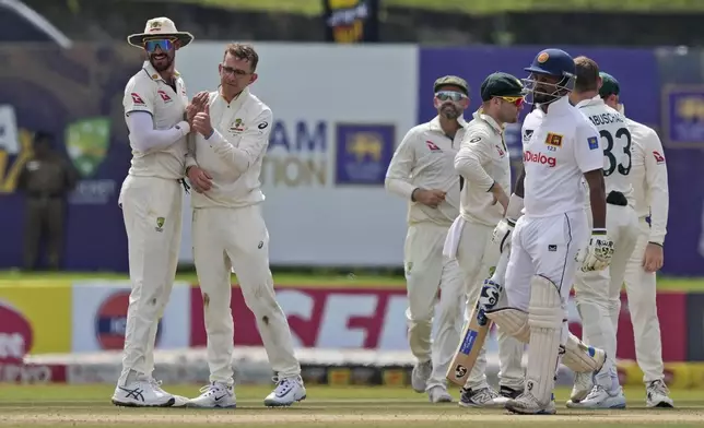 Australia's Todd Murphy celebrates the wicket of Sri Lanka's Dimuth Karunaratne during day four of the first test cricket match between Sri Lanka and Australia in Galle , Sri Lanka, Saturday, Feb. 1, 2025. (AP Photo/Eranga Jayawardena)