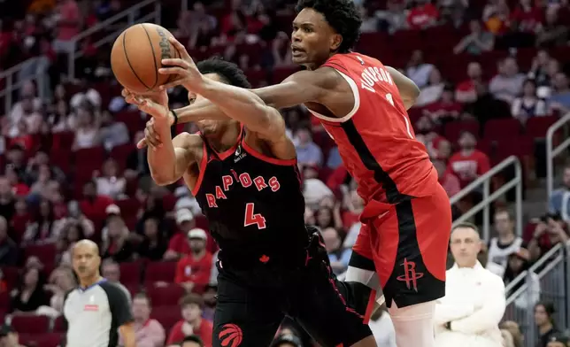 Houston Rockets forward Amen Thompson, right, fouls Toronto Raptors forward Scottie Barnes (4) during the first half of an NBA basketball game Sunday, Feb. 9, 2025, in Houston. (AP Photo/Eric Christian Smith)
