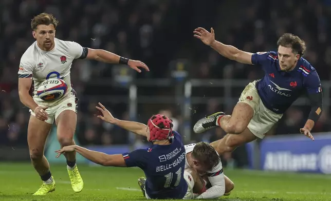 France's Louis Bielle-Biarrey offloads in the tackle during the Six Nations rugby union match between England and France at Twickenham in London, Saturday, Feb. 8, 2025. (AP Photo/Ian Walton)