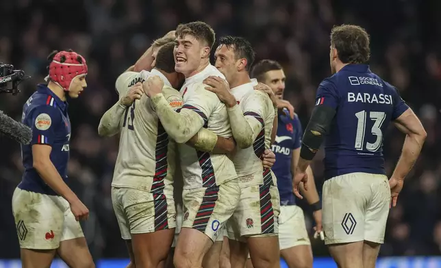 England's Tommy Freeman, center, celebrates after Elliot Daly scored a try during the Six Nations rugby union match between England and France at Twickenham in London, Saturday, Feb. 8, 2025. (AP Photo/Ian Walton)