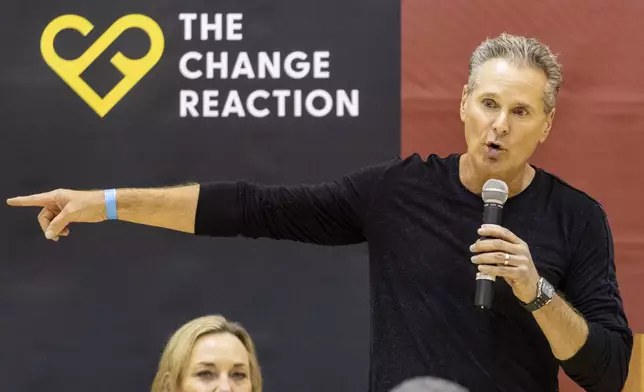 The Change Reaction founder Greg Perlman delivers a speech as he attends an event at the gymnasium of Pasadena City College where The Change Reaction will be handing out about 1,000 checks of between $2,500-$5,000 to people impacted by the Eaton Fire, Tuesday, Jan. 28, 2025 in Pasadena, Calif. (AP Photo/Etienne Laurent)