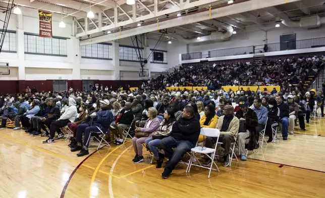 People impacted by the Eaton Fire attend an event at the gymnasium of Pasadena City College where The Change Reaction will be handing out about 1,000 checks of between $2,500-$5,000, Tuesday, Jan. 28, 2025 in Pasadena, Calif. (AP Photo/Etienne Laurent)