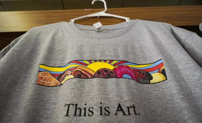 FILE -- A T-shirt showing the painting displayed outside Leavitt's Country Bakery, is displayed in the store in this April 13, 2023 file photo, in Conway, N.H. (AP Photo/Robert F. Bukaty, file)