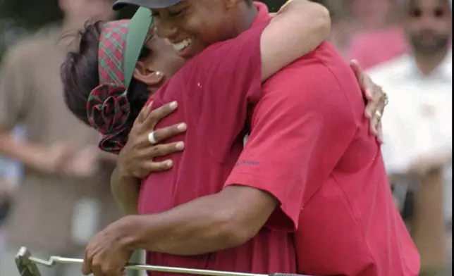 FILE - Tiger Woods is embraced by his mother, Kultida, after winning his third U.S. Amateur golf championship Sunday, Aug. 25, l996, at the Pumpkin Ridge Golf Club in North Plains, Ore. Woods defeated Steve Scott on the 38th hole.(AP Photo/Jack Smith, File)