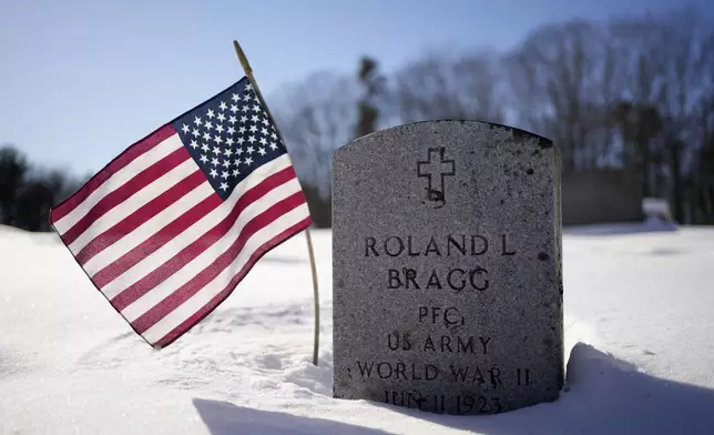 The gravestone of Pfc. Roland L. Bragg is seen Tuesday, Feb. 11, 2025, in Nobleboro, Maine. (AP Photo/Robert F. Bukaty)