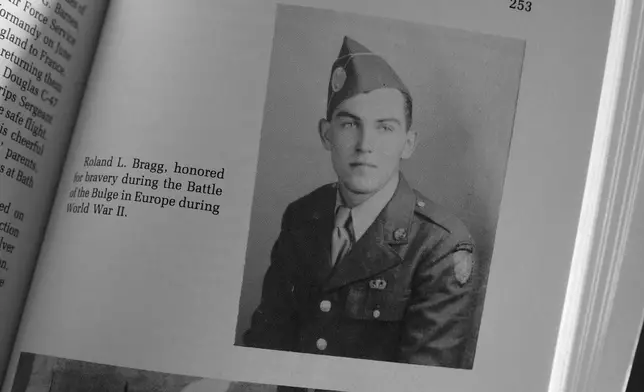 A military photo of Pfc. Roland L. Bragg is seen in a book about the history of Nobleboro, Maine, Tuesday, Feb. 11, 2025, in Nobleboro. (AP Photo/Robert F. Bukaty)