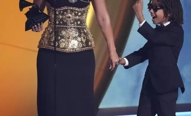 Alicia Keys accepts the Dr. Dre Global Impact Award during the 67th annual Grammy Awards on Sunday, Feb. 2, 2025, in Los Angeles. Genesis Ali Dean looks on from right.(AP Photo/Chris Pizzello)