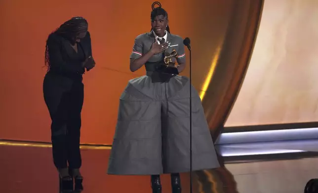 Doechii, center, accepts the award for best rap album for "Alligator Bites Never Heal" during the 67th annual Grammy Awards on Sunday, Feb. 2, 2025, in Los Angeles. Celesia Moore looks on from left(AP Photo/Chris Pizzello)