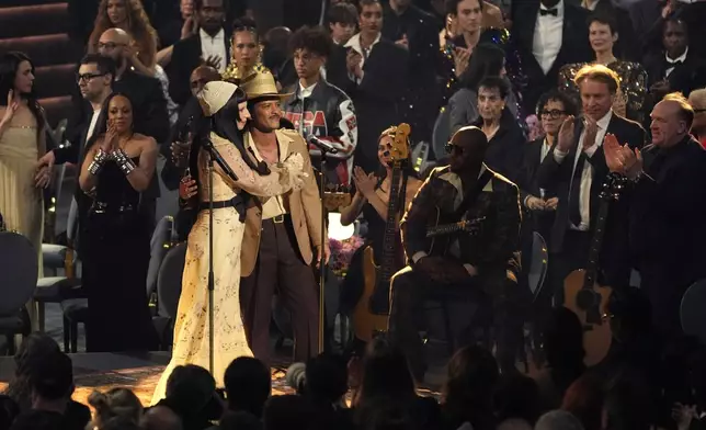 Lady Gaga, left, and Bruno Mars perform "California Dreamin'" during the 67th annual Grammy Awards on Sunday, Feb. 2, 2025, in Los Angeles. (AP Photo/Chris Pizzello)