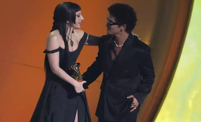 Lady Gaga, left, and Bruno Mars accept the award for best pop duo/group performance for "Die With A Smile" during the 67th annual Grammy Awards on Sunday, Feb. 2, 2025, in Los Angeles. (AP Photo/Chris Pizzello)