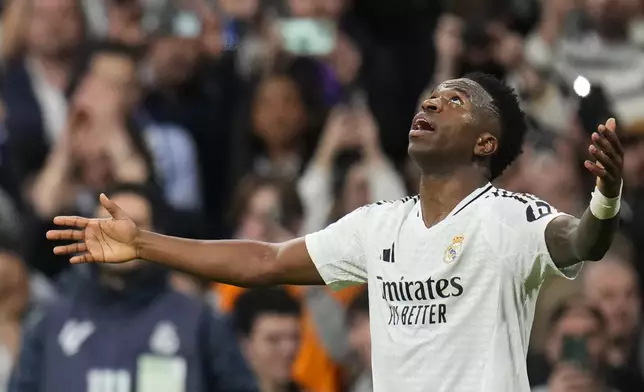 Real Madrid's Vinicius Junior celebrates after scoring his side's second goal during the Spanish La Liga soccer match between Real Madrid and Girona at the Santiago Bernabeu stadium in Madrid, Spain, Sunday, Feb. 23, 2025. (AP Photo/Manu Fernandez)