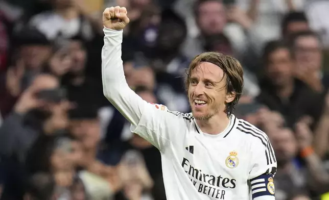 Real Madrid's Luka Modric celebrates after scoring the opening goal during the Spanish La Liga soccer match between Real Madrid and Girona at the Santiago Bernabeu stadium in Madrid, Spain, Sunday, Feb. 23, 2025. (AP Photo/Manu Fernandez)