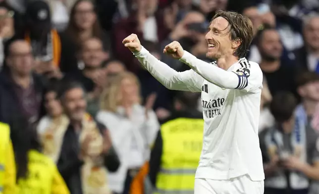 Real Madrid's Luka Modric celebrates after scoring the opening goal during the Spanish La Liga soccer match between Real Madrid and Girona at the Santiago Bernabeu stadium in Madrid, Spain, Sunday, Feb. 23, 2025. (AP Photo/Manu Fernandez)