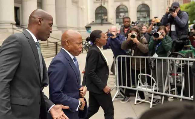 FILE - New York City Mayor Eric Adams, second from left, leaves the courthouse in New York, Oct. 2, 2024. (AP Photo/Seth Wenig, File)