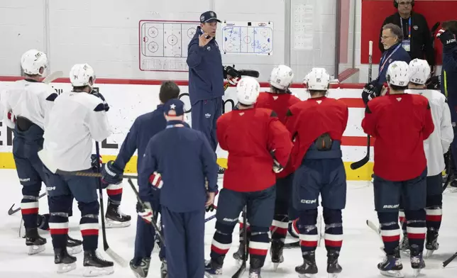 United States' coach Mike Sullivan speaks to his team during a 4 Nations Face-Off hockey practice in Brossard, Quebec, on Monday, Feb. 10, 2025. (Christinne Muschi/The Canadian Press via AP)