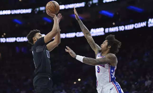 Brooklyn Nets' Cameron Johnson, left, goes up for a shot against Philadelphia 76ers' Kelly Oubre Jr. during the first half of an NBA basketball game, Saturday, Feb. 22, 2025, in Philadelphia. (AP Photo/Matt Slocum)
