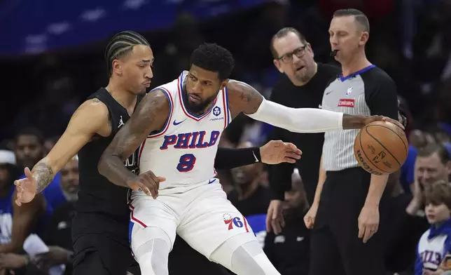 Philadelphia 76ers' Paul George, right, tries to get past Brooklyn Nets' Jalen Wilson during the first half of an NBA basketball game, Saturday, Feb. 22, 2025, in Philadelphia. (AP Photo/Matt Slocum)