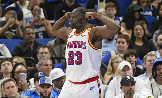 Golden State Warriors forward Draymond Green (23) flexes after making a shot and drawing a foul during the first half of an NBA basketball game against the Orlando Magic, Thursday, Feb. 27, 2025, in Orlando, Fla. (AP Photo/John Raoux)
