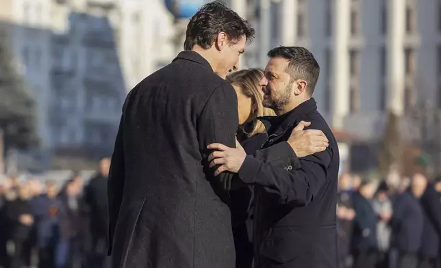 In this photo provided by the Ukrainian Presidential Press Office, Office shows Ukraine's President Volodymyr Zelensky, right, greeting Canada's Prime Minister Justin Trudeau during a ceremony in Kyiv, Ukraine, Monday, Feb. 24, 2025. (Ukrainian Presidential Press Office via AP)