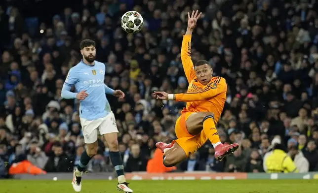 Real Madrid's Kylian Mbappe scores his sides first goal during the Champions League playoff first leg soccer match between Manchester City and Real Madrid at the Etihad Stadium in Manchester, England, Tuesday, Feb. 11, 2025. (AP Photo/Dave Thompson)