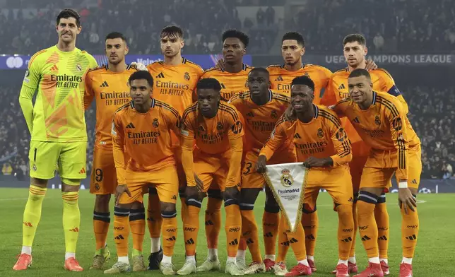 Real Madrid pose for a team group before the Champions League playoff first leg soccer match between Manchester City and Real Madrid at the Etihad Stadium in Manchester, England, Tuesday, Feb. 11, 2025. (AP Photo/Darren Staples)