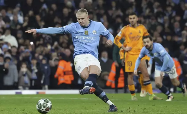 Manchester City's Erling Haaland scores his side's second goal from the penalty spot during the Champions League playoff first leg soccer match between Manchester City and Real Madrid at the Etihad Stadium in Manchester, England, Tuesday, Feb. 11, 2025. (AP Photo/Darren Staples)
