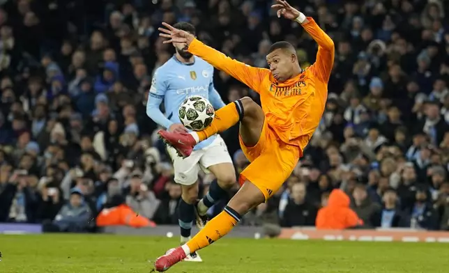 Real Madrid's Kylian Mbappe scores his sides first goal during the Champions League playoff first leg soccer match between Manchester City and Real Madrid at the Etihad Stadium in Manchester, England, Tuesday, Feb. 11, 2025. (AP Photo/Dave Thompson)