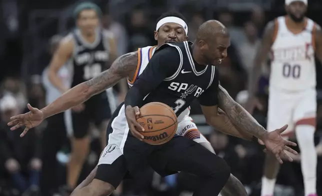 San Antonio Spurs guard Chris Paul (3) is pressured by Phoenix Suns guard Bradley Beal (3) during the second half of an NBA basketball game in Austin, Texas, Thursday, Feb. 20, 2025. (AP Photo/Eric Gay)