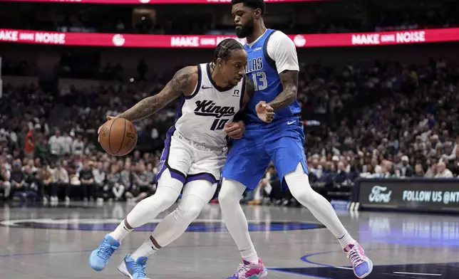 Sacramento Kings forward DeMar DeRozan (10) works for a shot against Dallas Mavericks forward Naji Marshall (13) in the first half of an NBA basketball game in Dallas, Monday, Feb. 10, 2025. (AP Photo/Tony Gutierrez)