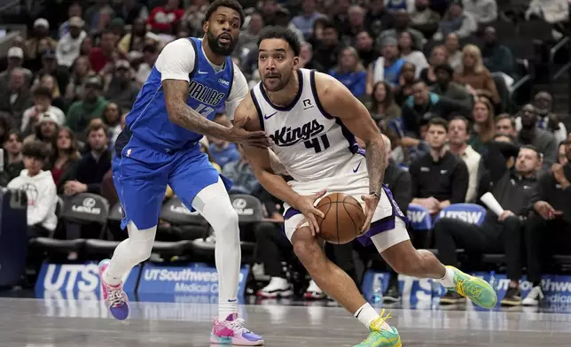Sacramento Kings forward Trey Lyles (41) works to the basket as Dallas Mavericks' Naji Marshall, left, defends in the first half of an NBA basketball game in Dallas, Monday, Feb. 10, 2025. (AP Photo/Tony Gutierrez)