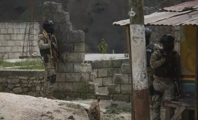 Police officers stand guard during an anti-gang operation in the Kenscoff neighborhood of Port-au-Prince, Haiti, Monday, Feb. 3, 2025. (AP Photo/Odelyn Joseph)
