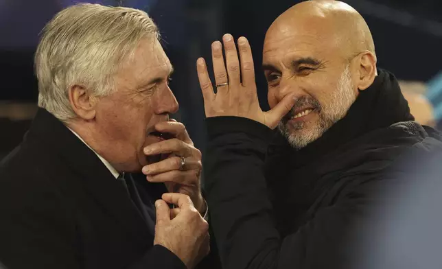Real Madrid's head coach Carlo Ancelotti, left and Manchester City's head coach Pep Guardiola share a laugh before the Champions League playoff first leg soccer match between Manchester City and Real Madrid at the Etihad Stadium in Manchester, England, Tuesday, Feb. 11, 2025. (AP Photo/Darren Staples)