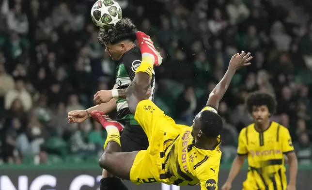 Dortmund's Serhou Guirassy challenges for the ball with Sporting's Maximiliano Araujo during the Champions League playoff first leg soccer match between Sporting CP and Borussia Dortmund at the Alvalade stadium in Lisbon, Portugal, Tuesday, Feb. 11, 2025. (AP Photo/Armando Franca)