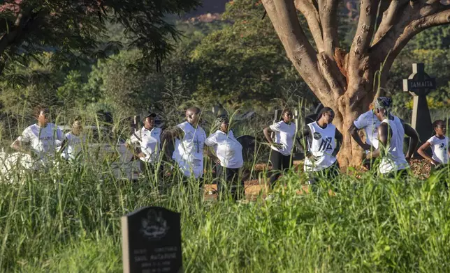 Members of the Commandos Fitness Club exercise at the Warren Hills cemetery in Harare, Zimbabwe, Saturday, Jan. 18, 2025. ( AP Photo/Aaron Ufumeli)