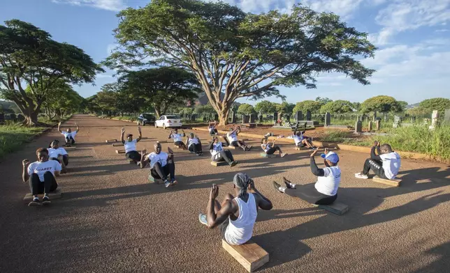 Members of the Commandos Fitness Club exercise at the Warren Hills cemetery in Harare, Zimbabwe, Saturday, Jan. 18, 2025. ( AP Photo/Aaron Ufumeli)