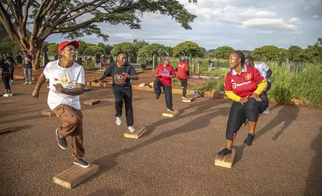 Nelly Mutandwa, 65, exercises with the Commandos Fitness Club at the Warren Hills cemetery in Harare, Zimbabwe, Saturday, Jan. 18, 2025. ( AP Photo/Aaron Ufumeli)