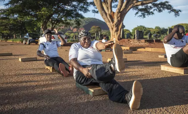 Susan Gomo, 65, exercises with the Commandos Fitness Club at the Warren Hills cemetery in Harare, Zimbabwe, Saturday, Jan. 18, 2025. ( AP Photo/Aaron Ufumeli)