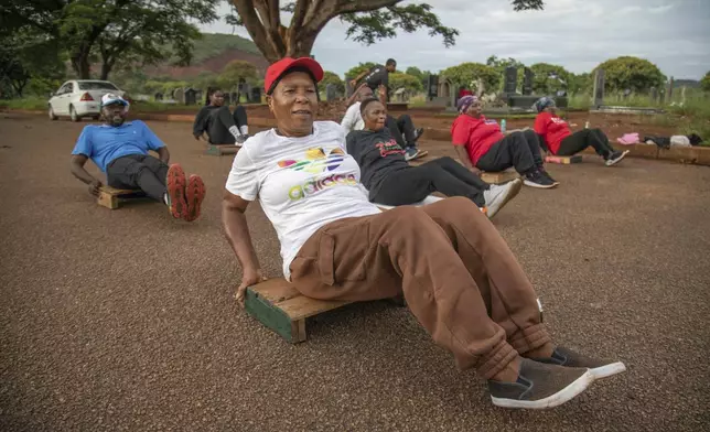 Nelly Mutandwa, 65, exercises with the Commandos Fitness Club at the Warren Hills cemetery in Harare, Zimbabwe, Saturday, Jan. 18, 2025. ( AP Photo/Aaron Ufumeli)