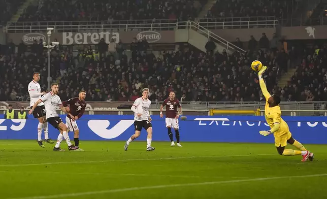 Torino's Nikola Vlasic, second left, has a shot on goal towards AC Milan's goalkeeper Mike Maignan during the Italian Serie A soccer match between Torino and AC Milan the Stadio Olimpico Grande Torino in Turin, north west Italy, Saturday, Feb. 22, 2025. (Fabio Ferrari/LaPresse via AP)