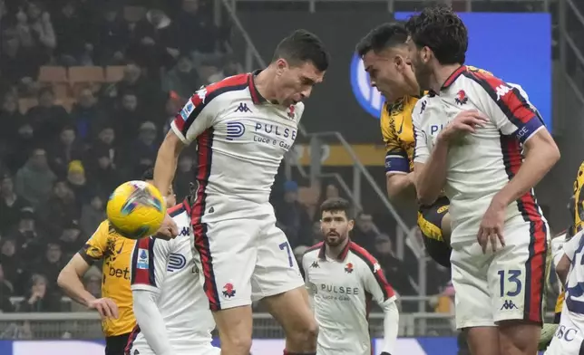 Inter Milan's Lautaro Martinez, second right, scores his side's opening goal during a Serie A soccer match between Inter Milan and Genoa, at the San Siro stadium in Milan, Italy, Saturday, Feb. 22, 2025. (AP Photo/Luca Bruno)