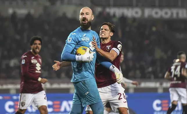 Torino's goalkeeper Vanja Milinkovic-Savic and Torino's Samuele Ricci celebrates after saving a penality during the Italian Serie A soccer match between Torino and AC Milan the Stadio Olimpico Grande Torino in Turin, north west Italy, Saturday, Feb. 22, 2025. (Alberto Gandolfo/LaPresse via AP)