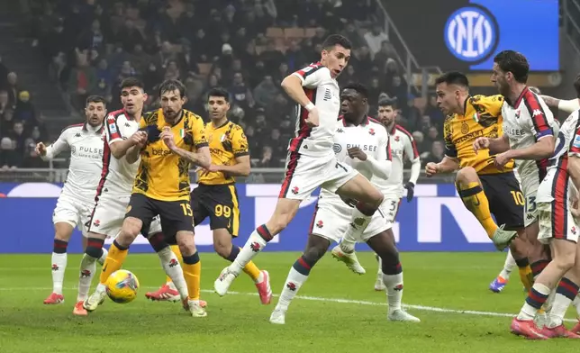 Inter Milan's Lautaro Martinez, second right, scores his side's opening goal during a Serie A soccer match between Inter Milan and Genoa, at the San Siro stadium in Milan, Italy, Saturday, Feb. 22, 2025. (AP Photo/Luca Bruno)