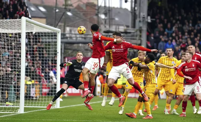 Nottingham Forest's Morgan Gibbs-White scores his side's second goal of the game during the Premier League match between Brighton and Nottingham Forest at the City Ground, Nottingham, England, Saturday Feb. 1, 2025. (Martin Rickett/PA via AP)