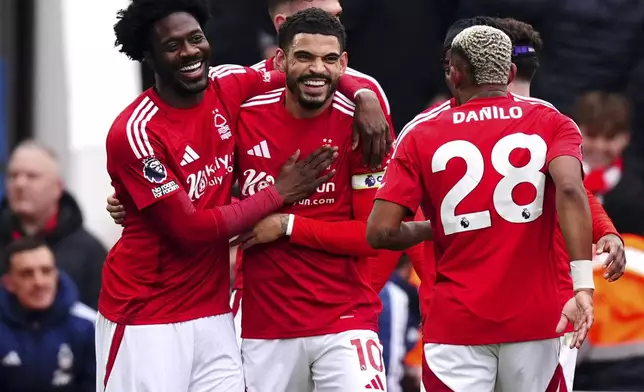 Nottingham Forest's Morgan Gibbs-White celebrates assisting the opening goal, an own goal scored by Brighton and Hove Albion's Lewis Dunk, not pictured, during the Premier League match between Brighton and Nottingham Forest at the City Ground, Nottingham, England, Saturday Feb. 1, 2025. (Martin Rickett/PA via AP)