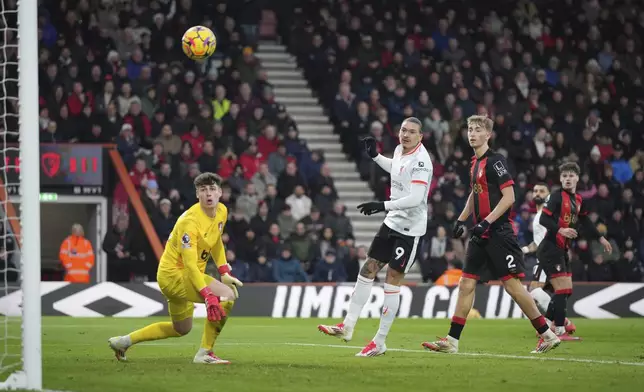 Liverpool's Mohamed Salah, background right, scores his side's second goal during the English Premier League soccer match between Bournemouth and Liverpool at the Vitality stadium in Bournemouth, England, Saturday, Feb. 1, 2025. (AP Photo/Alastair Grant)