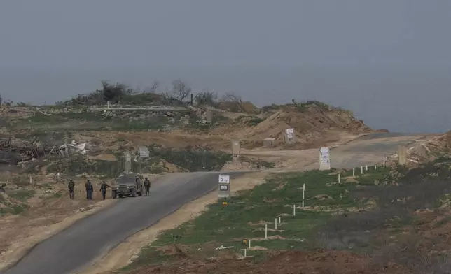 Israeli soldiers inside the northern Gaza Strip as seen from southern Israel, Sunday, Feb. 9, 2025. (AP Photo/Ohad Zwigenberg)